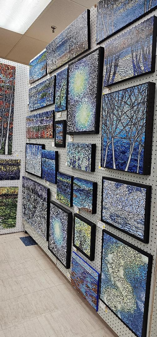 Anne Borbey-Schwartz paintings on pegboard wall at Amherst Artisan's Gallery